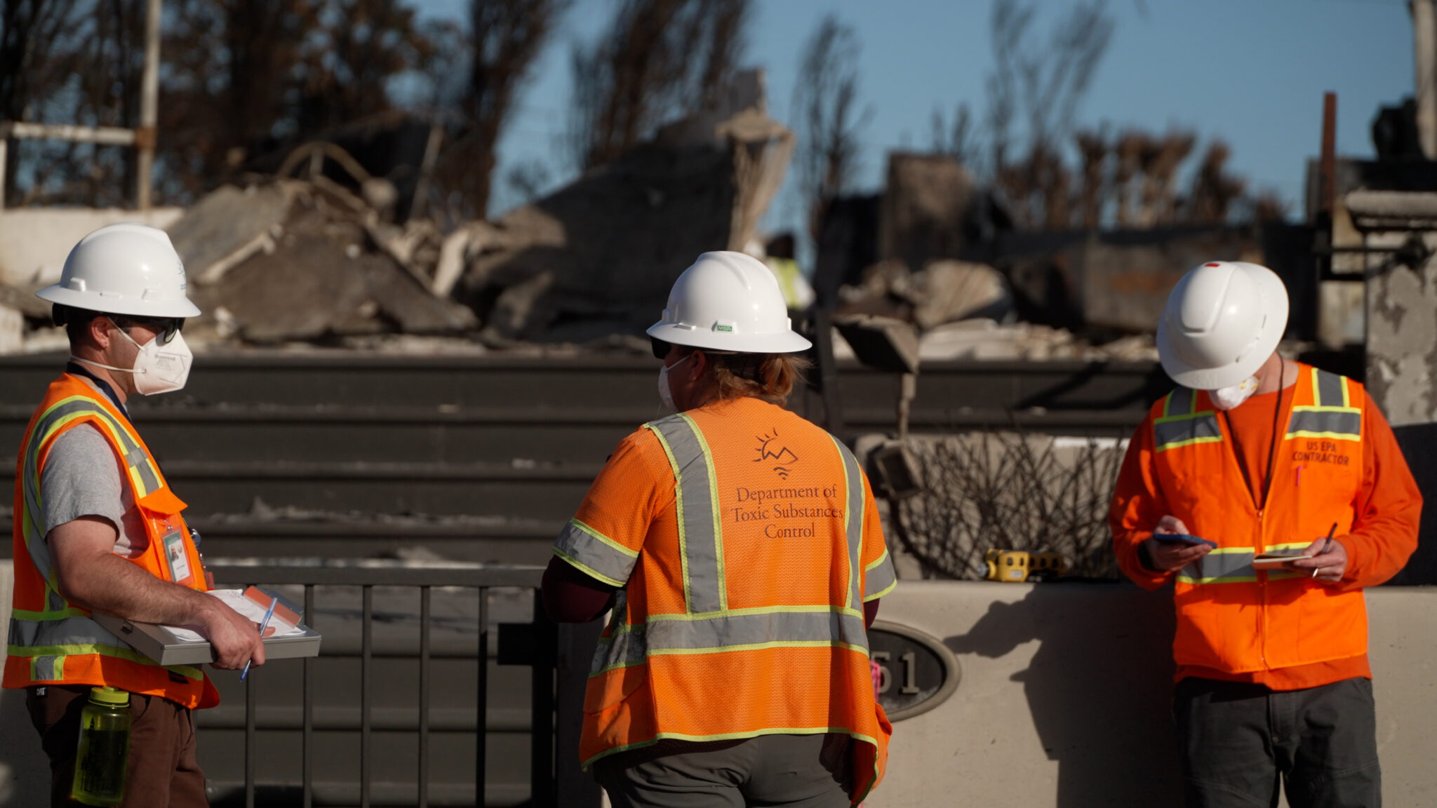 Image of DTSC staff in front of a burned property in LA County