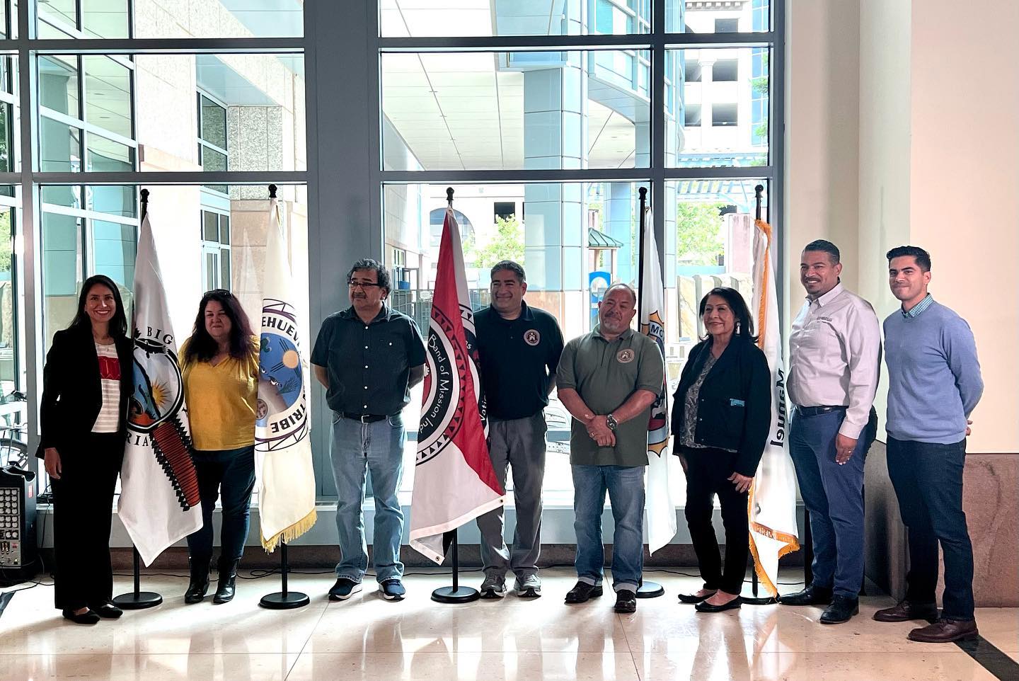 CalEPA staff and Tribal Advisory Committee members with tribal flags.